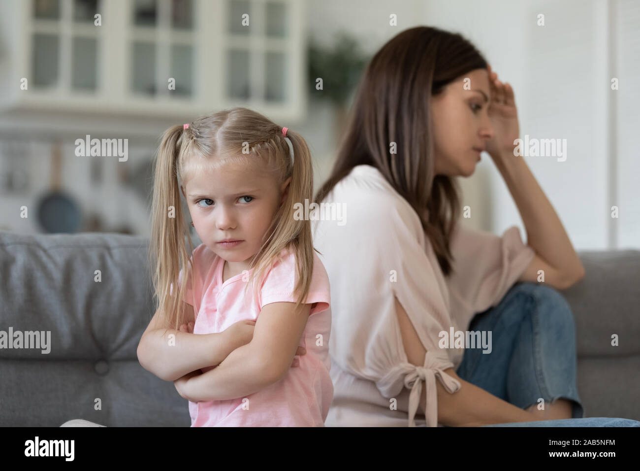 Naughty stubborn child daughter and mum avoid talk after argument Stock Photo