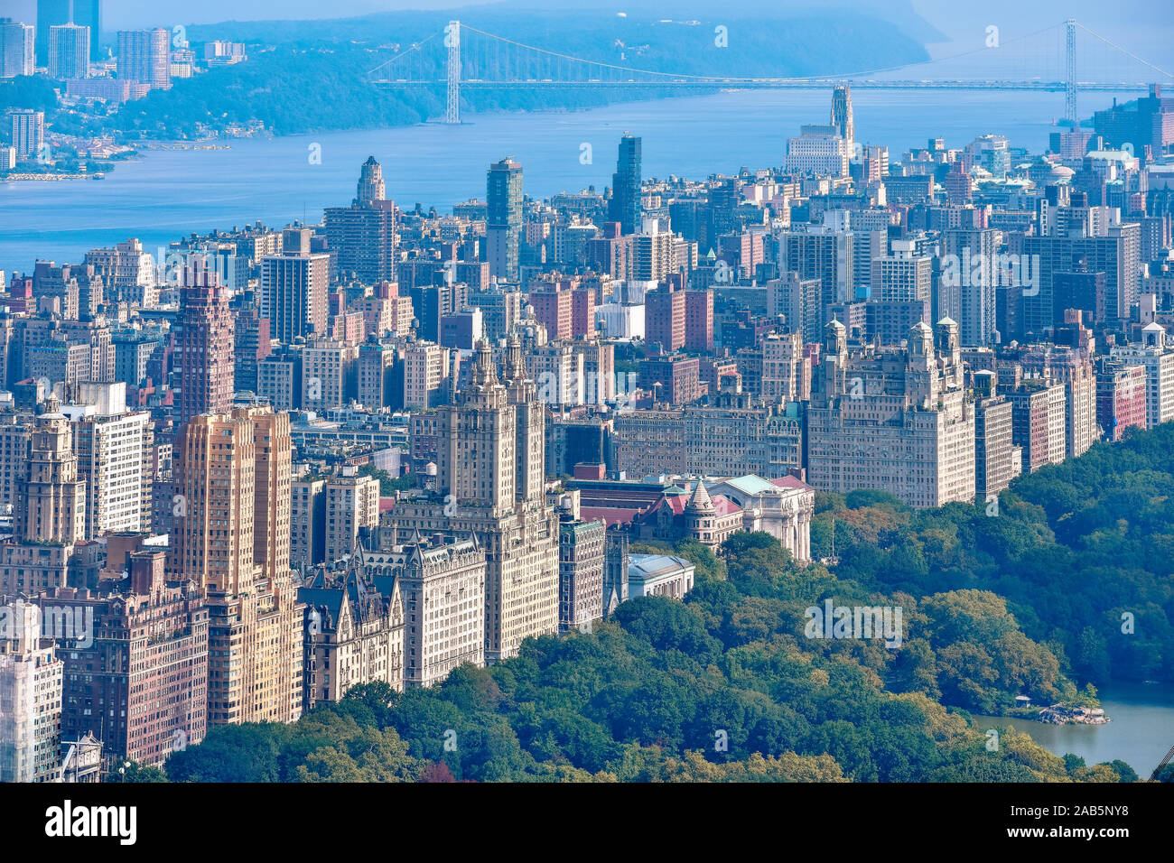 Aerial view of Central Park and row of buildings on the Upper West Side. Hudson River and George Washington Bridge in the background. Manhattan, New Y Stock Photo