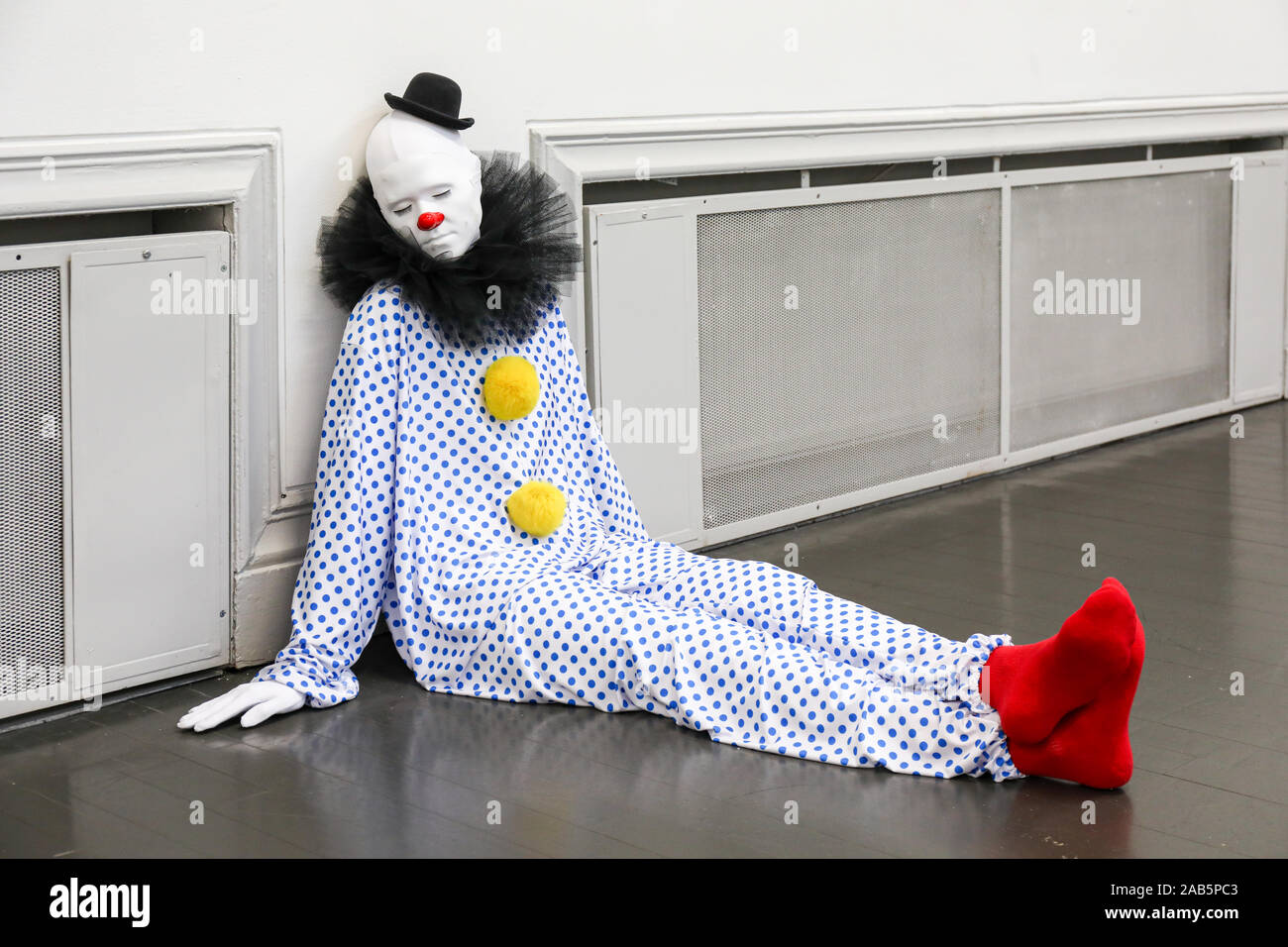 Hyper-realistic clown sculpture at 'everone gets lighter' or 'vocabulary of solitude' contemporary art exhibition by Ugo Rondinone in Helsinki Stock Photo