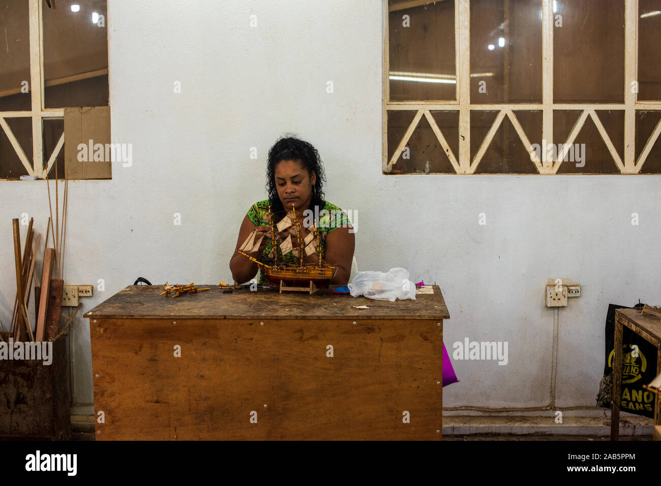 Mauritius January 21, 2018. An artist works on a wooden model ship in a small studio on