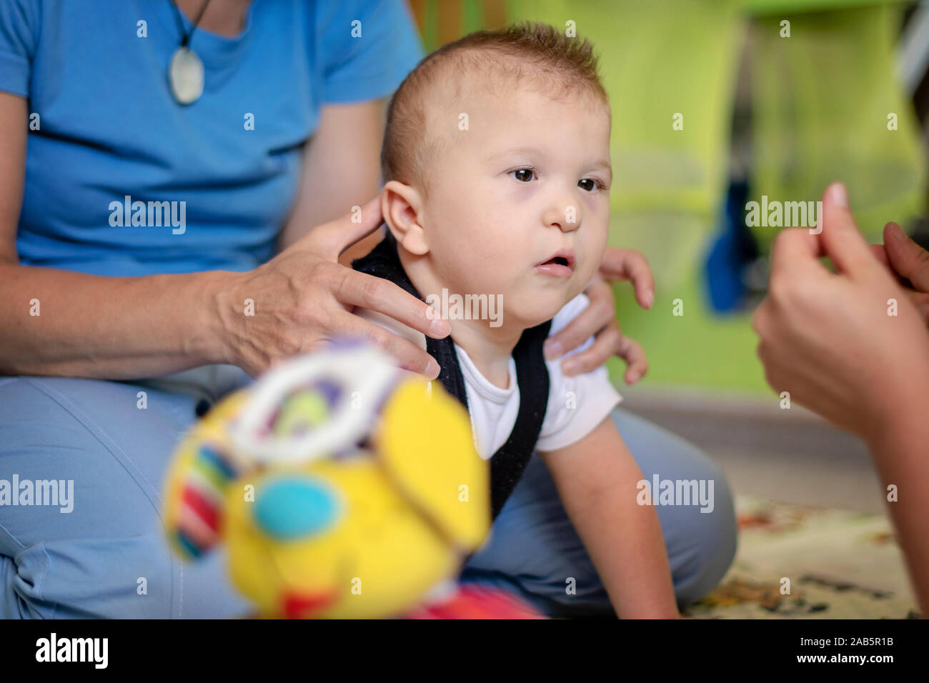 Portrait of a baby with cerebral palsy on physiotherapy in a children