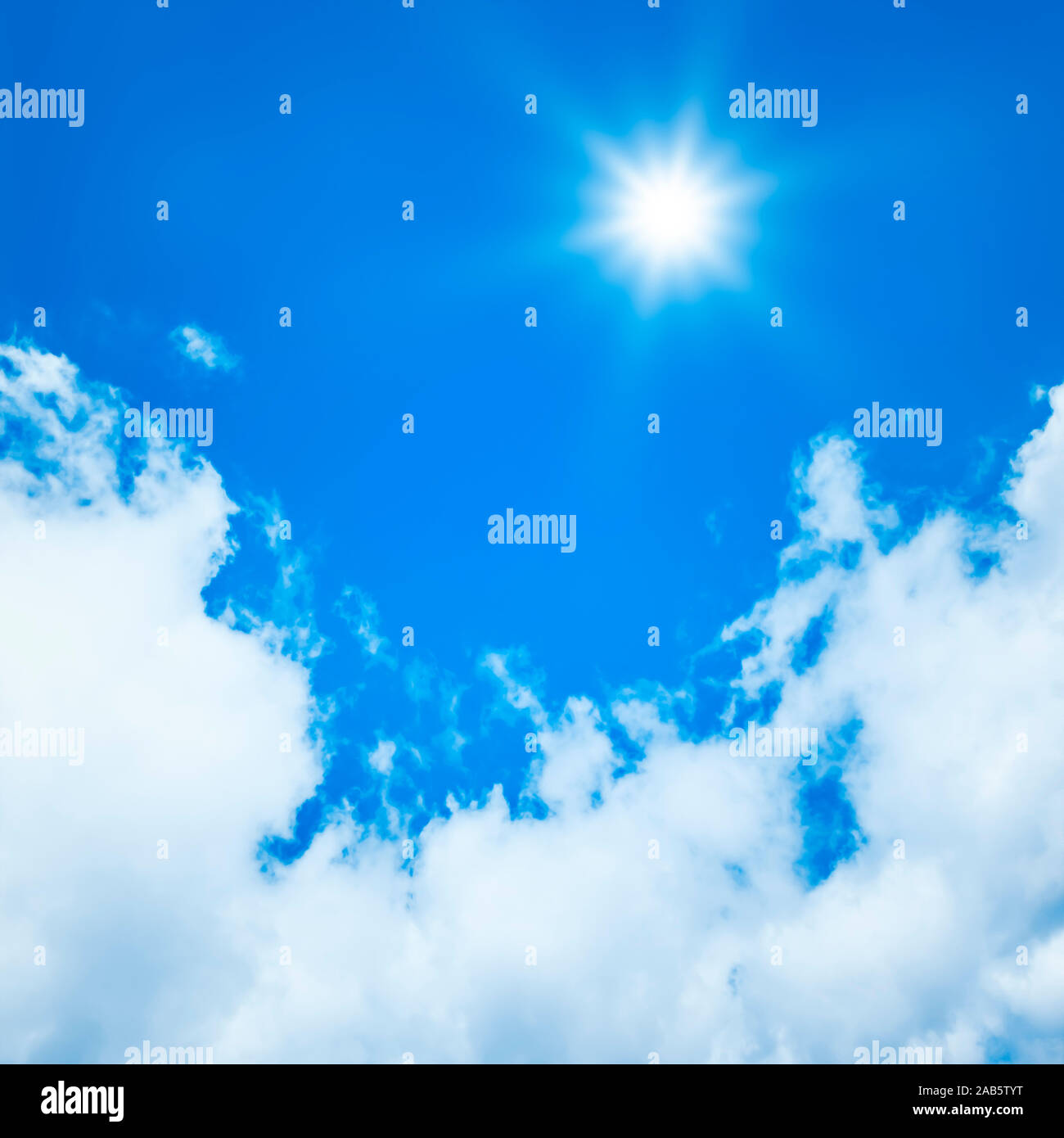 Ein wunderschoener blauer Himmel mit weissen Wolken und strahlender Sonne Stock Photo