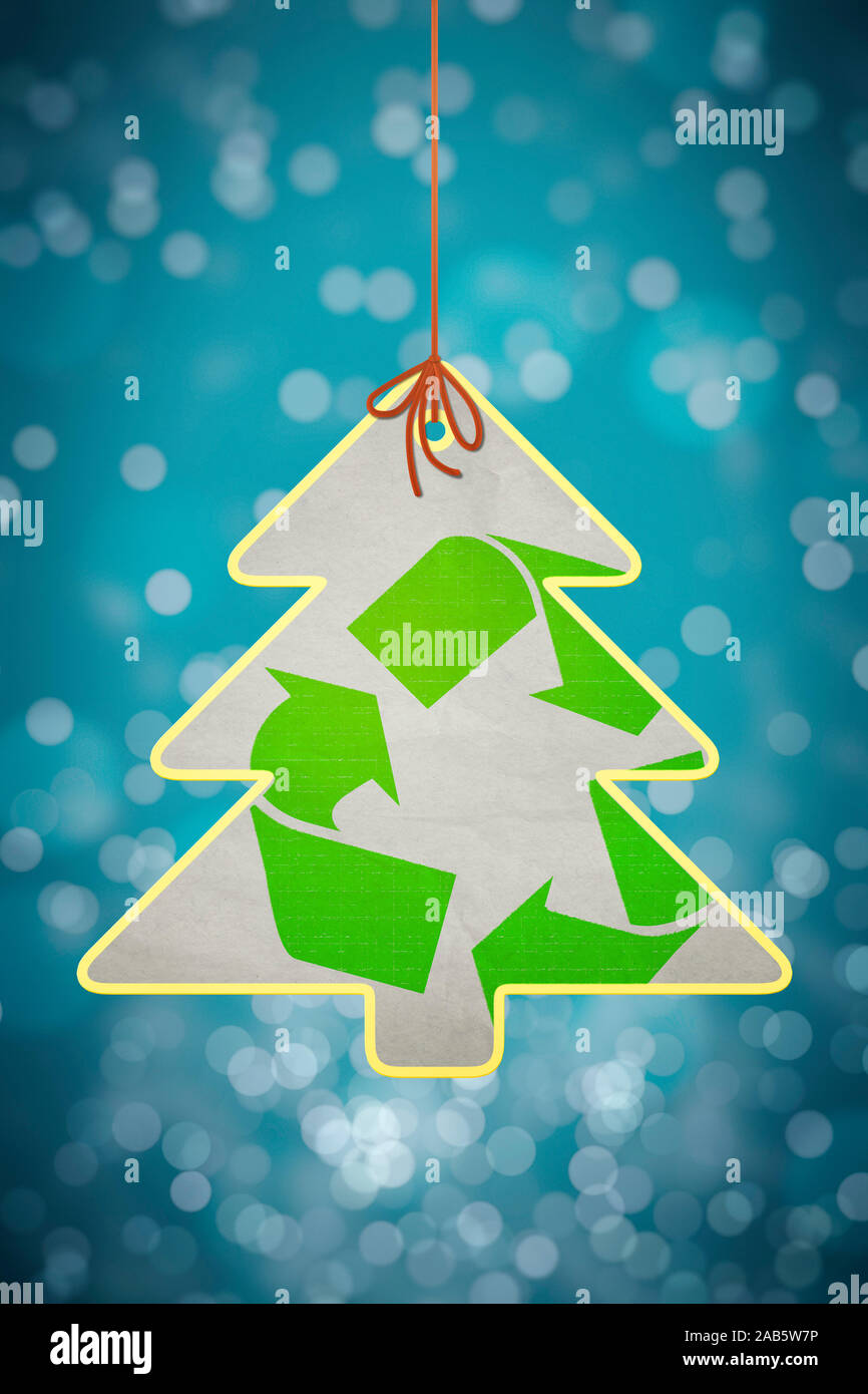 Ein kleiner Tannenbaum vor einem farbenfrohen Hintergrund, der ein Recycling-Symbol traegt Stock Photo