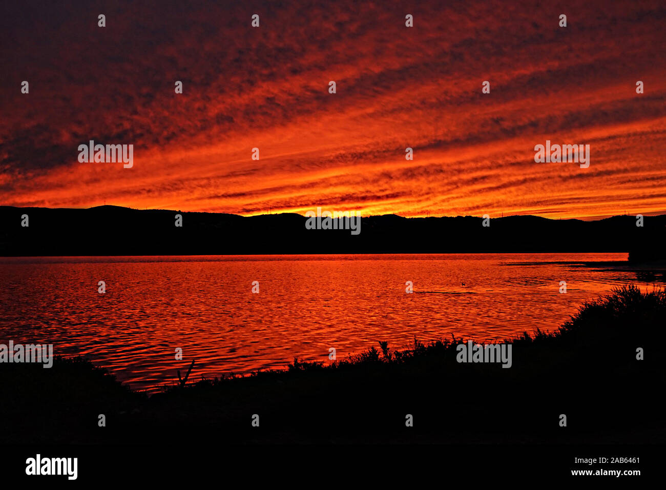 Black silhouette landscape against a colourful sunset sky Stock Photo