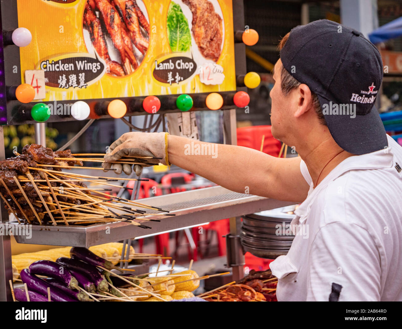 Malaysian man serving on seafood market stall in Bukit Bintang Kuala