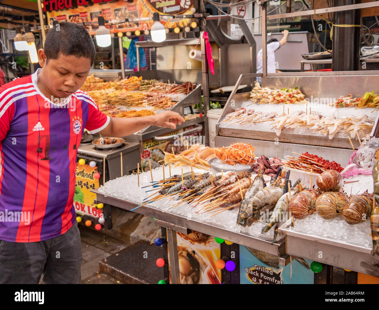 Malaysian man serving on seafood market stall in Bukit Bintang Kuala
