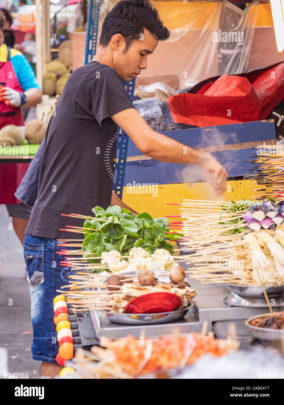Malaysian man serving on seafood market stall in Bukit Bintang Kuala