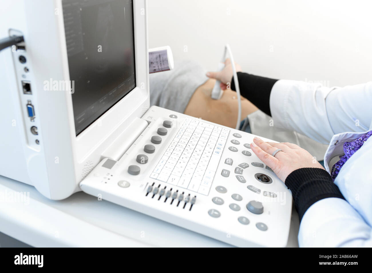 Closeup ultrasound machine doctor performs ultrasound diagnosis of the abdomen and internal