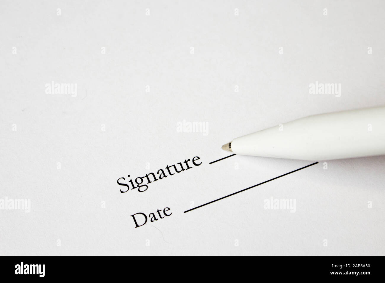 pen with signature and document in background. Focus on tip of fountain pen nib. Stock Photo