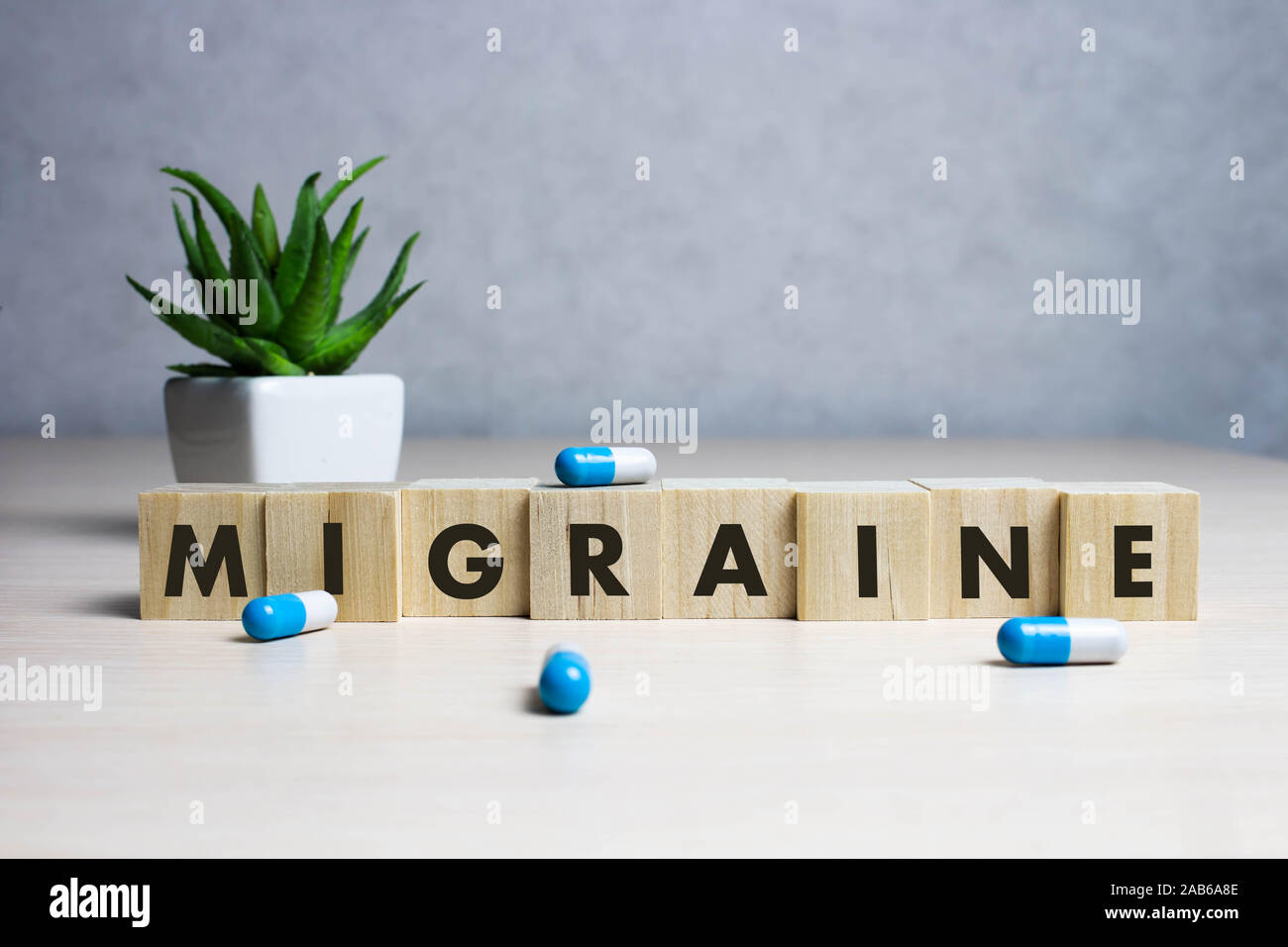Stock photo The word Migraine along with paracetamol tablets Stock