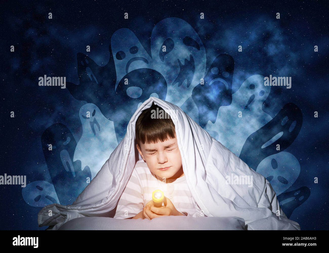 Scared boy hiding under blanket Stock Photo Alamy