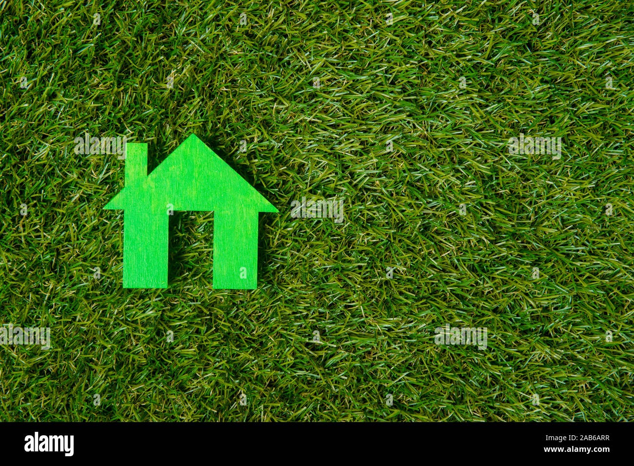 Green house on green grass background. Eco friendly Stock Photo - Alamy