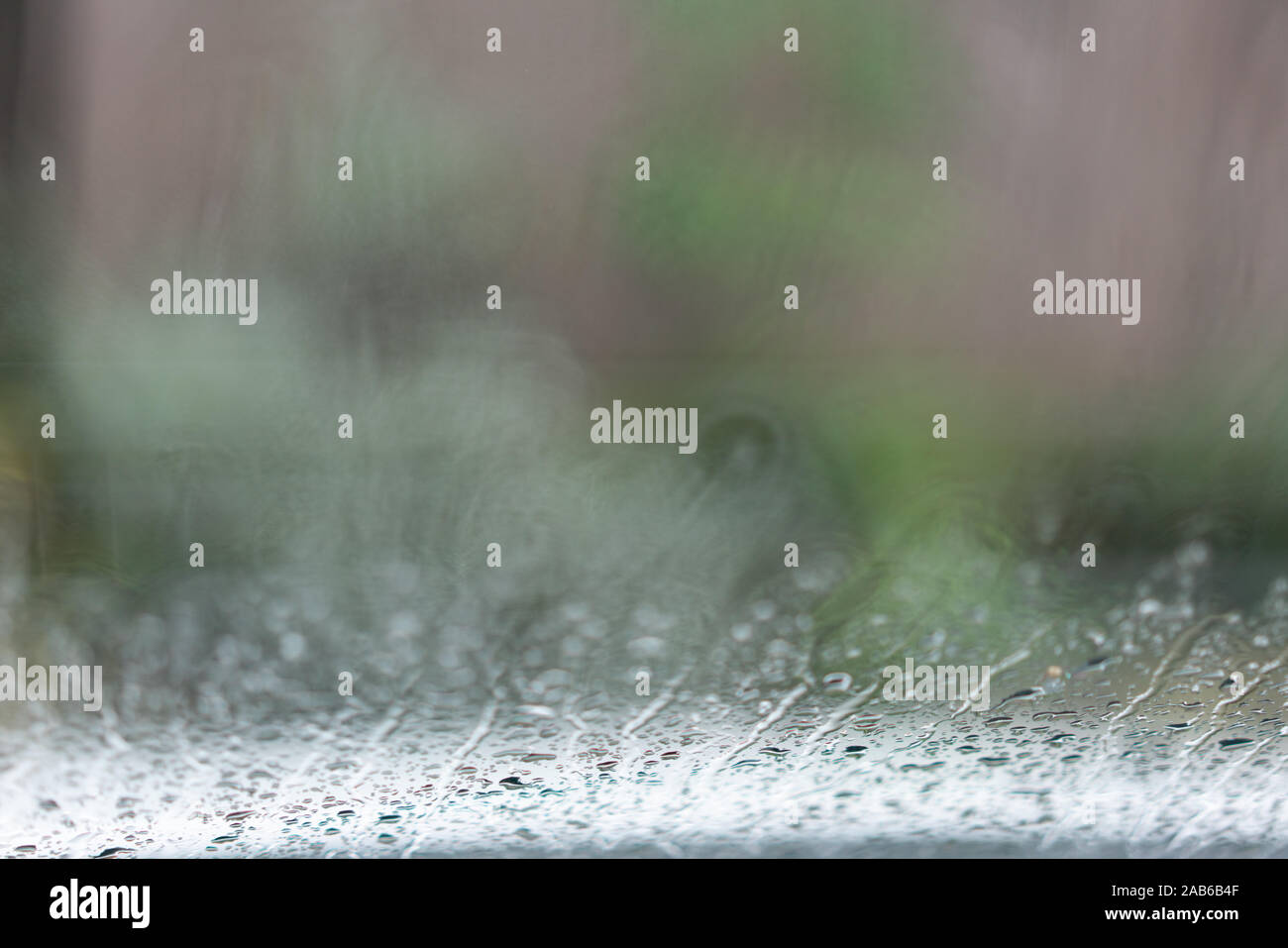 Raindrops on a glass, unsharp background, view through the window Stock
