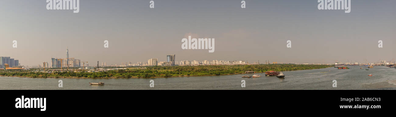Ho Chi Minh City, Vietnam - March 13, 2019: Evening panorama shot over Song Sai Gon River onto the new parts of the city with its skyscrapers of offic Stock Photo