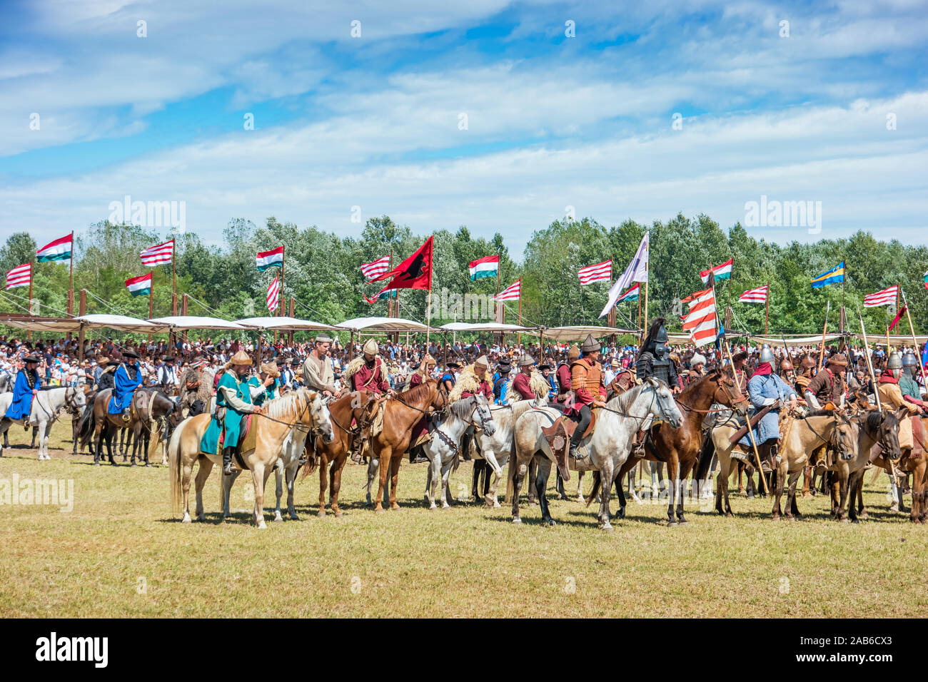 Horsemen in historic costumes stand during the Day of Ancestors tribal assembly in the Hungarian steppe near Bugac, Hungary. Stock Photo