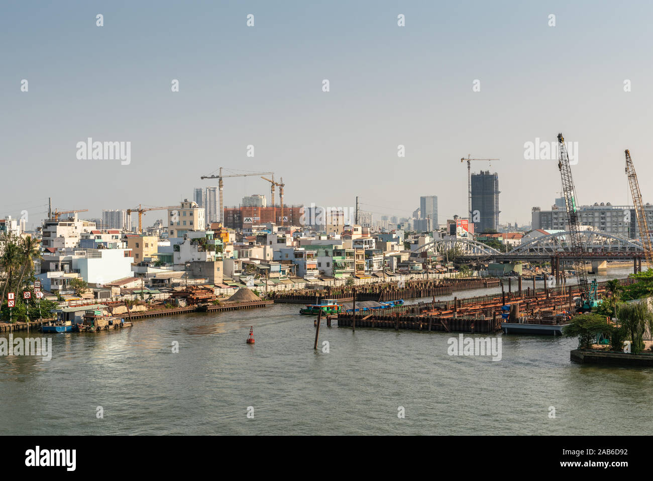 Ho Chi Minh City, Vietnam - March 13, 2019: Downtown port on Song Sai Gon river at sunset. Where Kenh Te canal connects we find harbor instatllations Stock Photo