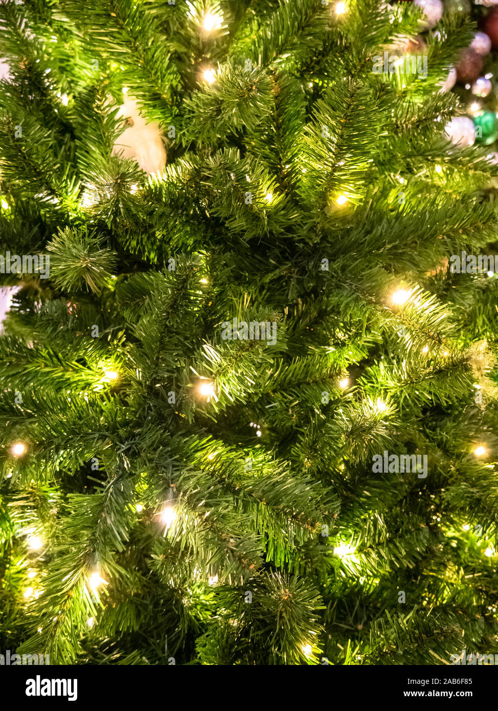 Green Christmass tree fir texture with lights and balls background ...
