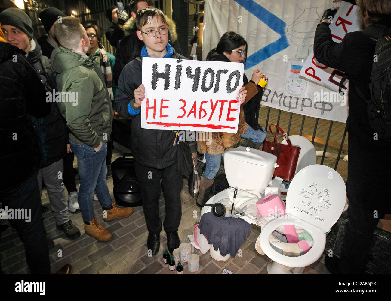 An activist holds a placard that says nothing is forgotten in a performance called the Humanitarian Aid for Russians during the protest outside the Embassy of Russia in Kiev.As media reported, three Ukrainian naval vessels Berdiansk, Nikopol and Yany Kapu, seized by Russia almost a year ago and were returned to the Ukrainian port of Ochakiv on 20 November 2019 in poor condition, with dismantled weapons, communications and navigation equipment and without some parts of equipment and including ceiling lights, sockets and toilet bowls. Ukrainian ships which were seized by the Russian Federation a Stock Photo