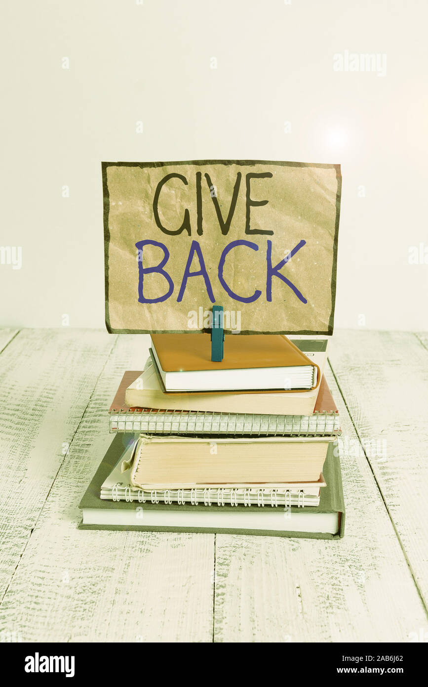 Conceptual Hand Writing Showing Give Back Concept Meaning The Act Of Giving Someone Something That They Owned Or Had Before Pile Stacked Books Notebo Stock Photo Alamy
