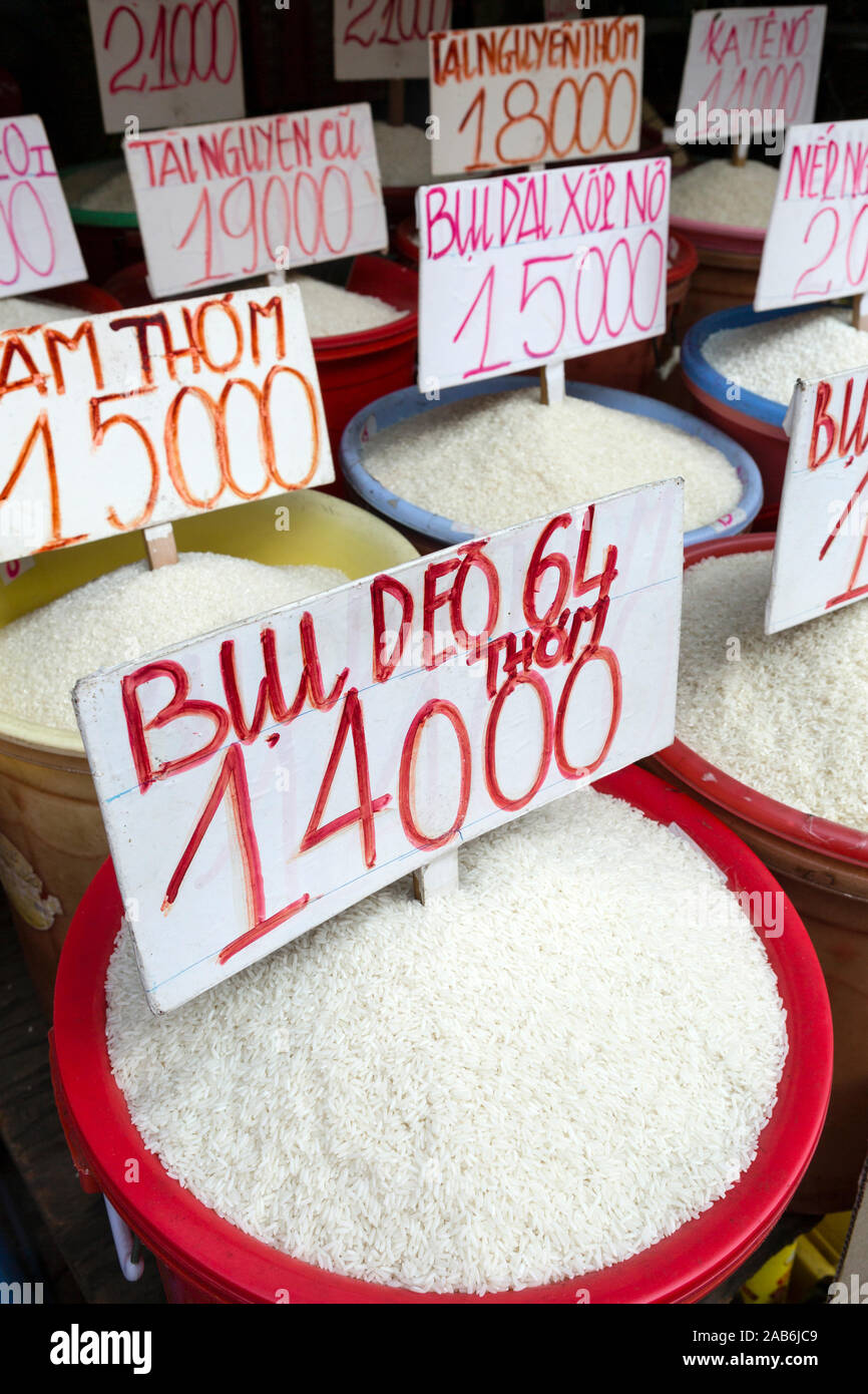 Containers of white rice for sale in a local street market in Ho Chi Minh City, Vietnam. Stock Photo