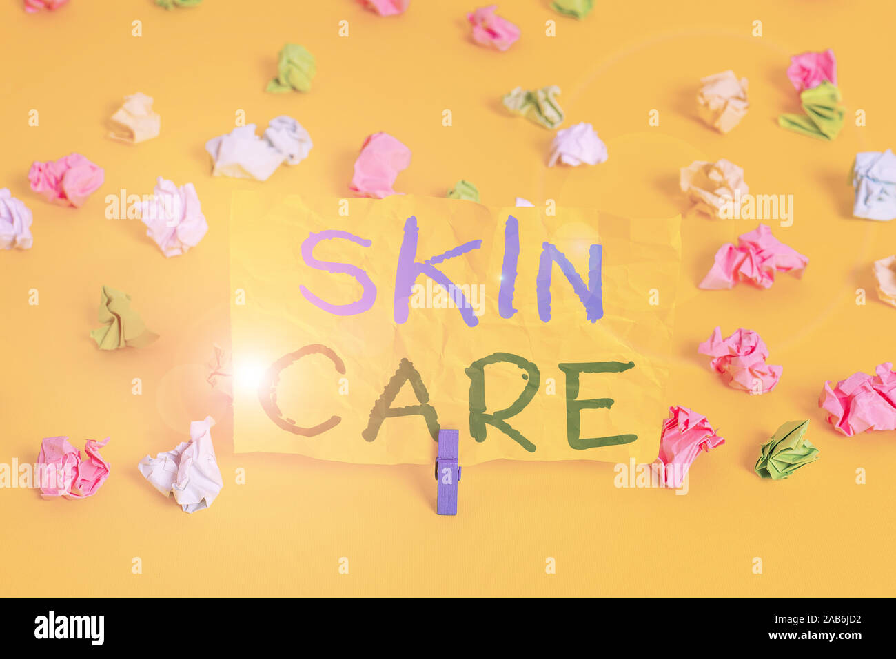 Handwriting text writing Skin Care. Conceptual photo things that you do or use to keep your skin healthy and attractive Colored crumpled papers empty Stock Photo