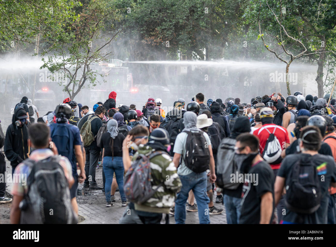 Violence and clashes between the police and protesters at Plaza Italia square during the latest riots at Santiago city streets. Tear gas and disorders Stock Photo