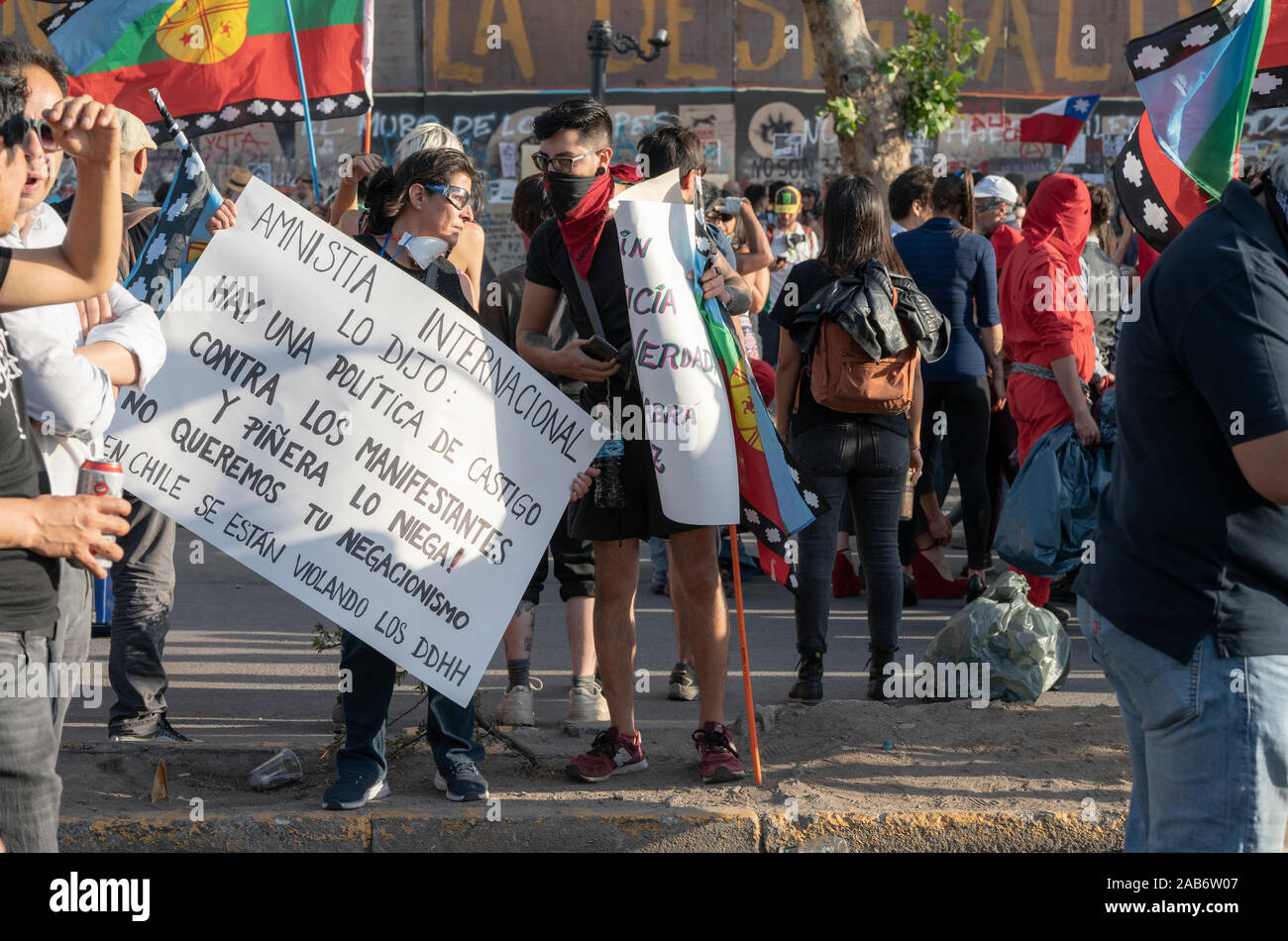 Protester with International Amnesty signs. People crowds protesting at Santiago de Chile streets in Plaza de Italia during latest Chile protests Stock Photo