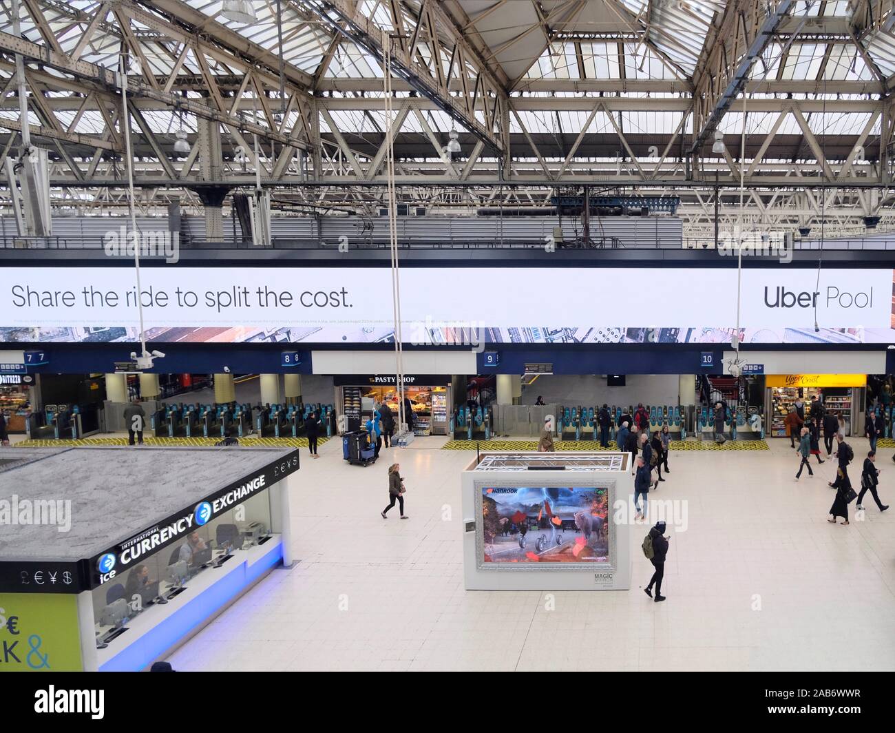 Uber advertising board at London Waterloo. As of 25/11/19 Uber was stripped of it's licence to operate in the city by the Mayor of London. Stock Photo