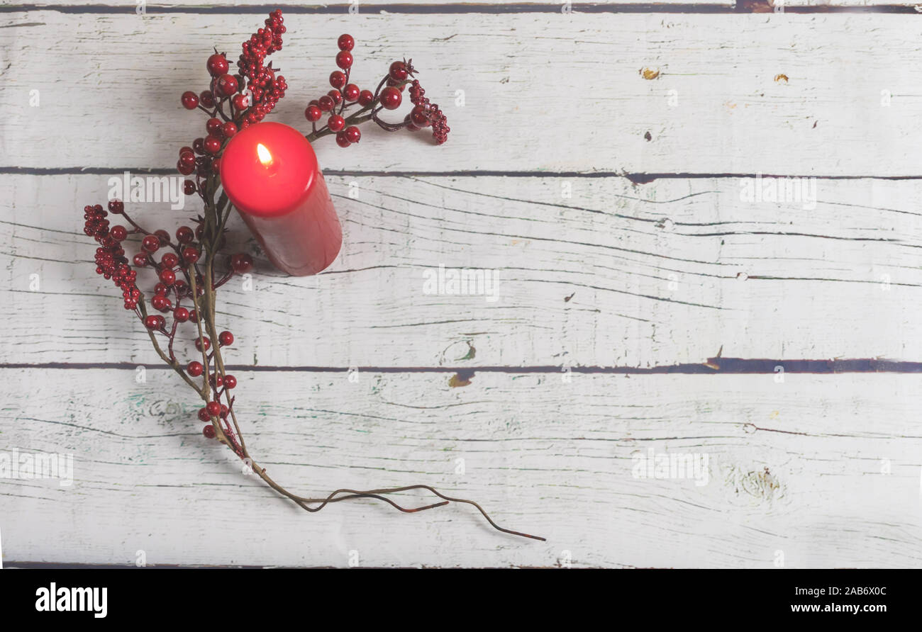 Red Christmas decoration, candle and Christmas motifs on a white wooden background Stock Photo