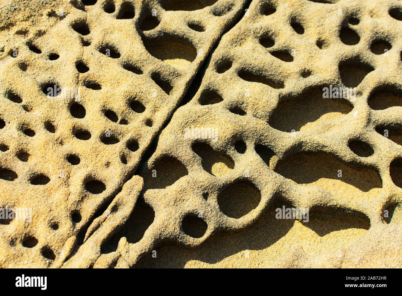 Tafoni formation, uniquely textured sandstone, cave like features and honeycomb like structures created in rock through a weathering process. Stock Photo