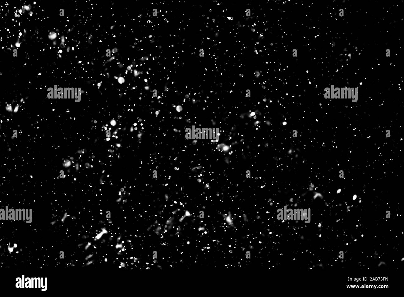 Snow on black background Stock Photo - Alamy