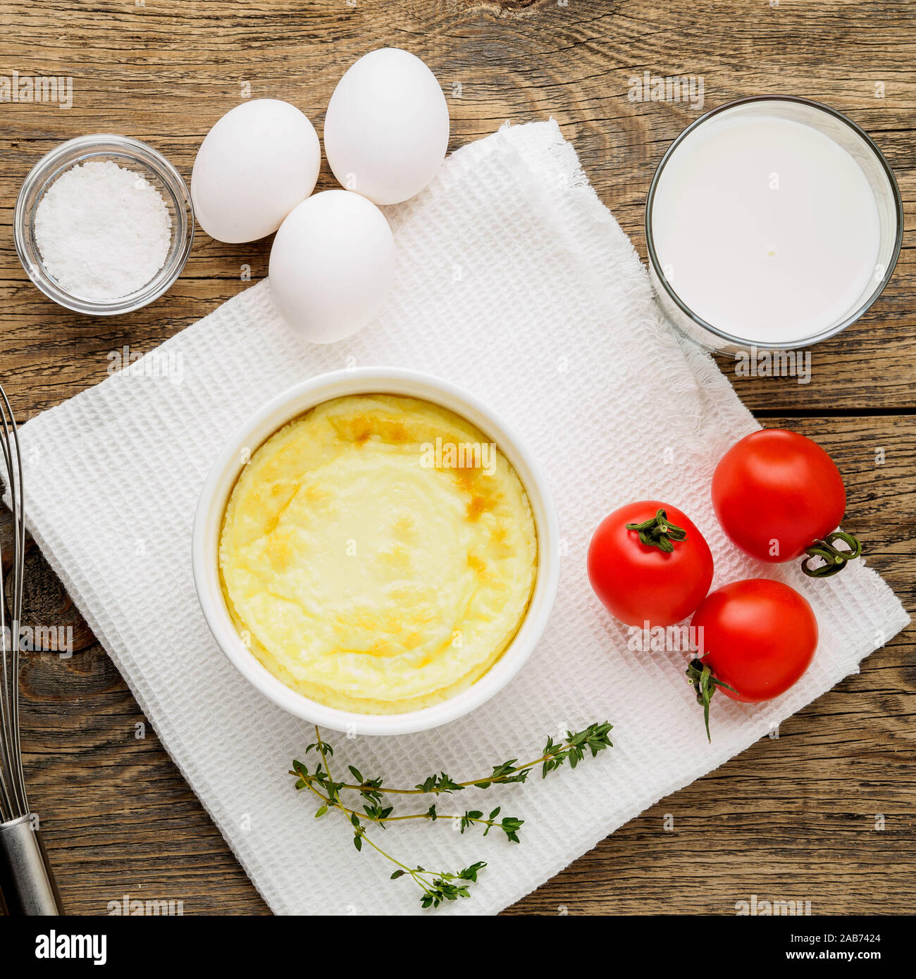 white round ramekin with ovenbaked omelet of eggs and milk, with a