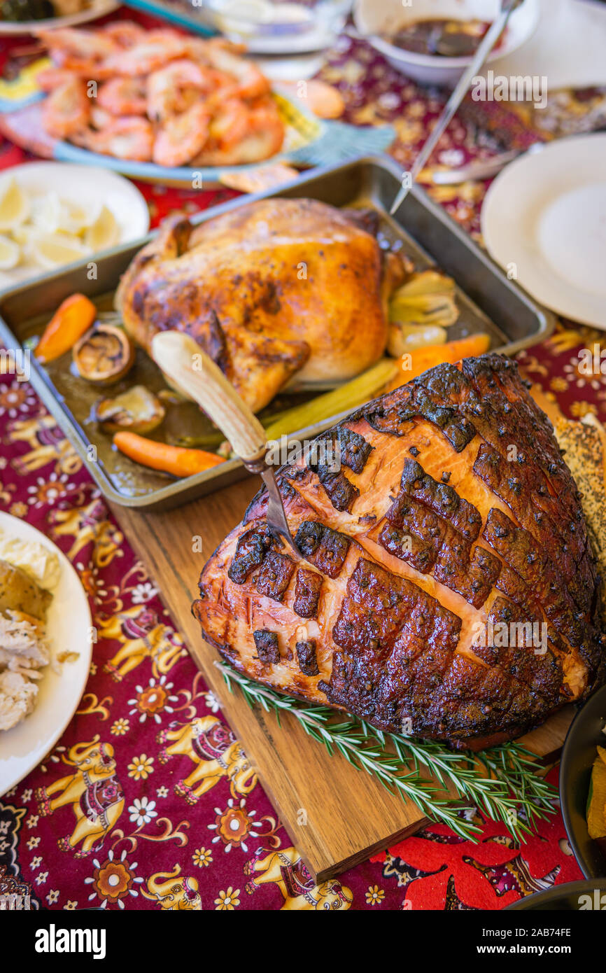 Modern Australian Christmas dinner table with glazed ham, prawns, roast