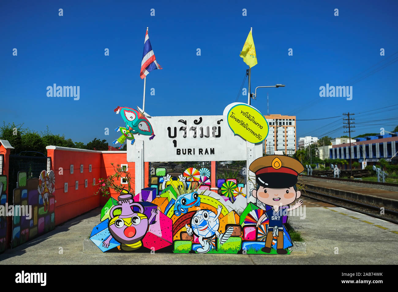 Colorful board for travel promoted in Buri Ram train station, Thailand. (Translation:Buri Ram and Bon Voyage in yellow textbox) Stock Photo