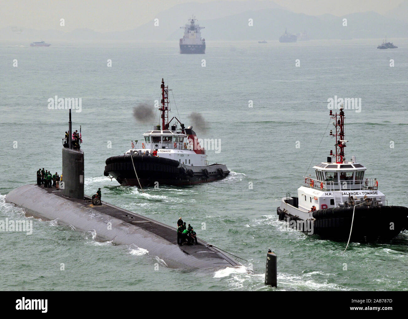 (May 20, 2011) The Los Angeles-class attack submarine USS Hampton (SSN 767) gets underway from Victoria Harbor after receiving support from the submarine tender USS Frank Cable (AS 40). Frank Cable conducts maintenance and support of submarines and surface vessels deployed in the U.S. 7th Fleet area of responsibility. Stock Photo