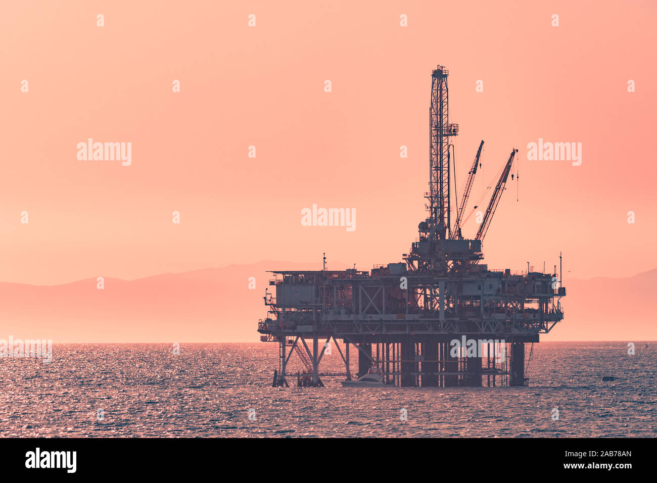 An oil rig far in the distance on the ocean Stock Photo