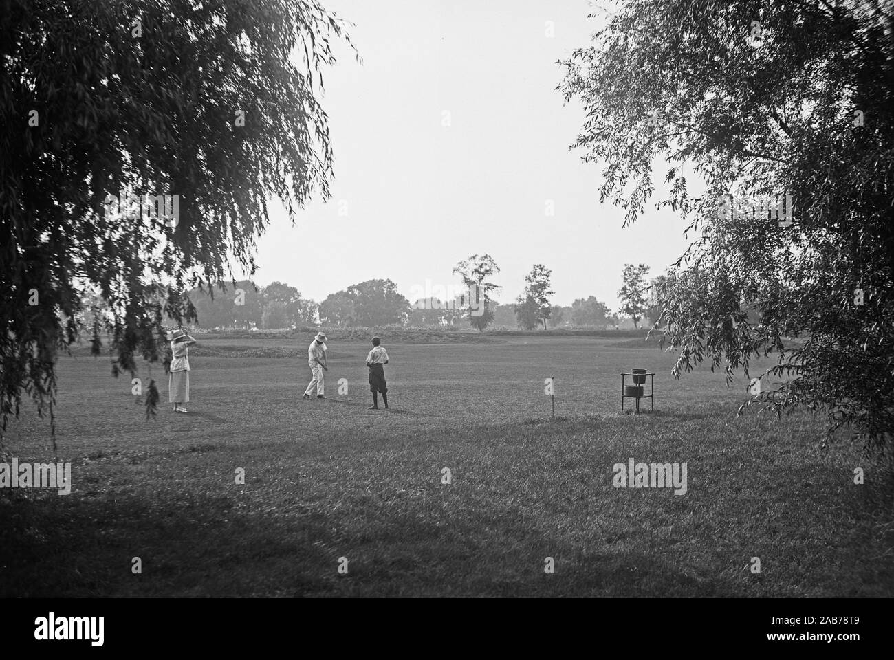 Vintage Golf Photo - A group of golfers on a golf course fairway ca. 1915-1923 Stock Photo