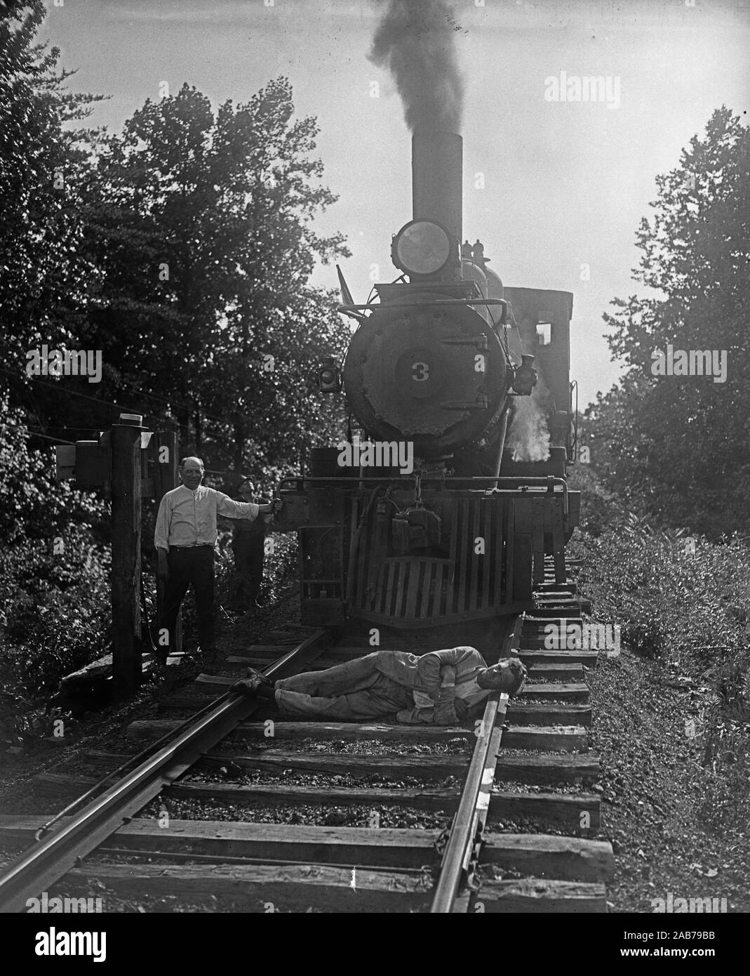 Man lying in front of train on tracks ca. June or July 1926 Stock Photo