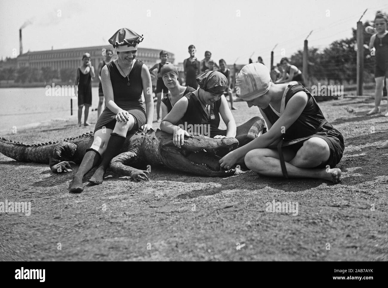 Tidal basin bathing with stuffed alligator on beach, Washington, D.C. ca. 1919-1923 Stock Photo