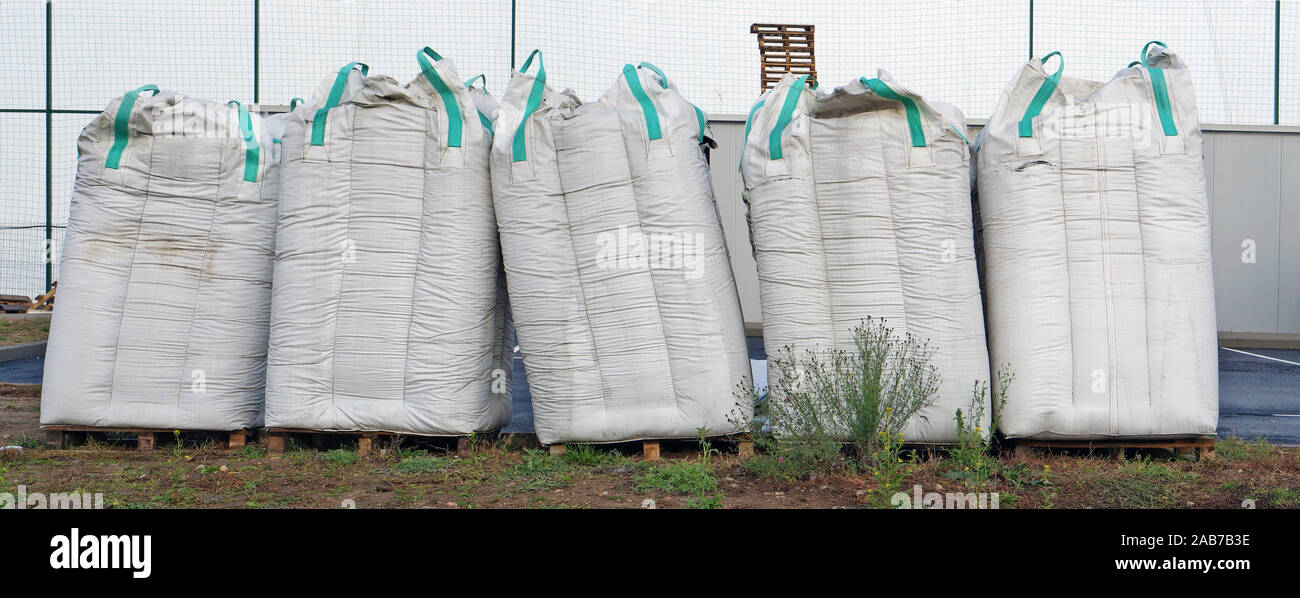 The five big bags with construction debris is made of a white synthetic