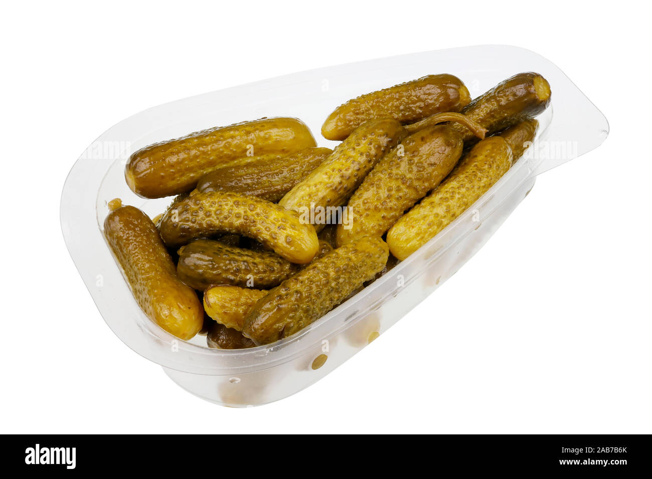 Daily food product - small pickled green gherkins cucumbers  in a transparent plastic container. Isolated with patch  on white studio macro Stock Photo
