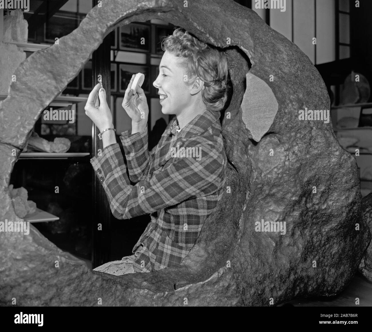 Woman posing with the Tucson Ring meteorite at the Smithsonian Museum of Natural History, Washington, D.C. ca. 1938 or 1939 Stock Photo