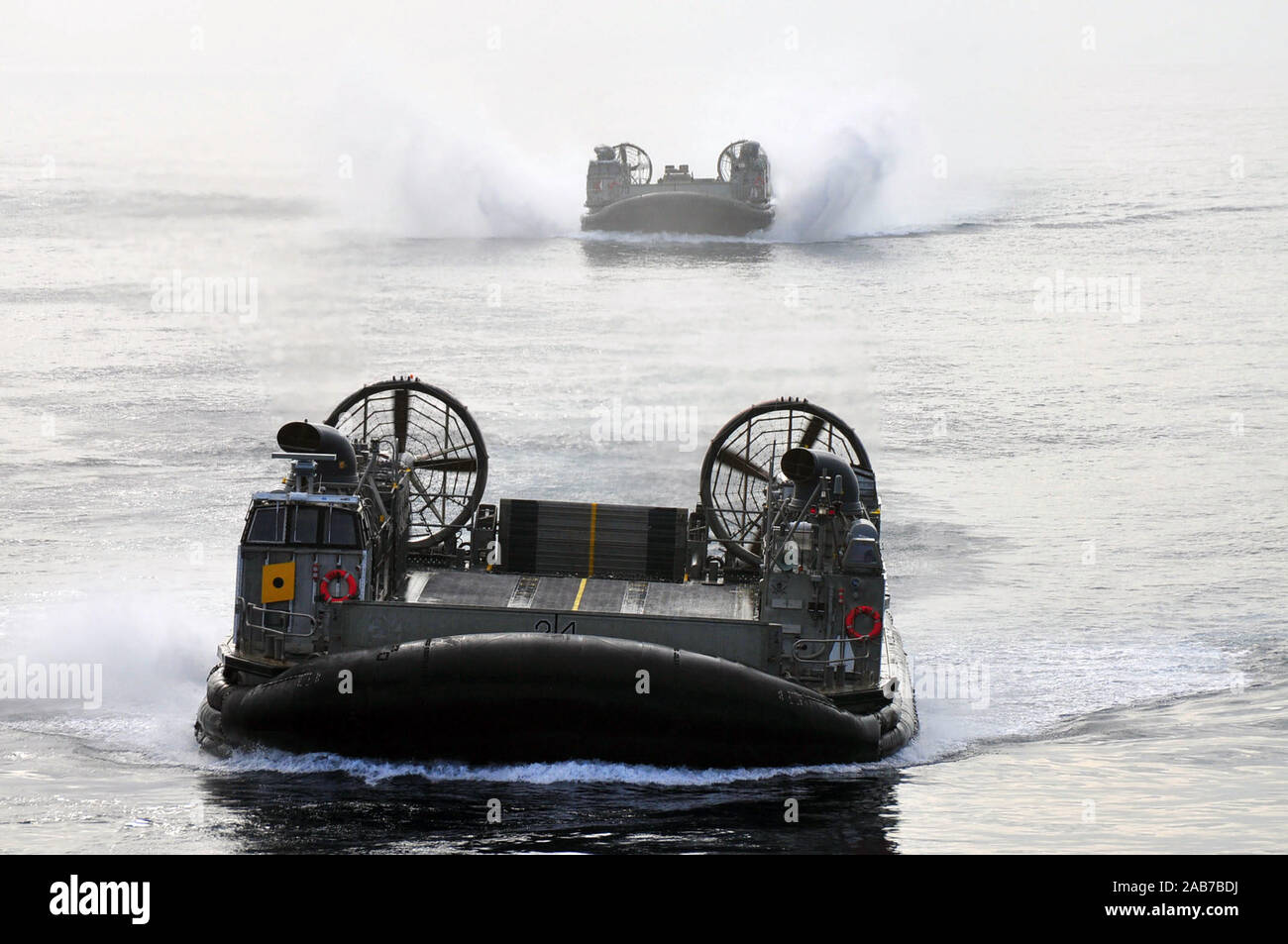 SAN DIEGO (Aug. 30, 2012) Landing Craft Air Cushion (LCAC) 24 and 73, from Assault Craft Unit (ACU) 5, approach the well deck of the amphibious assault ship USS Boxer (LHD 4).  Boxer is currently underway off the coast of Southern Calif. Stock Photo