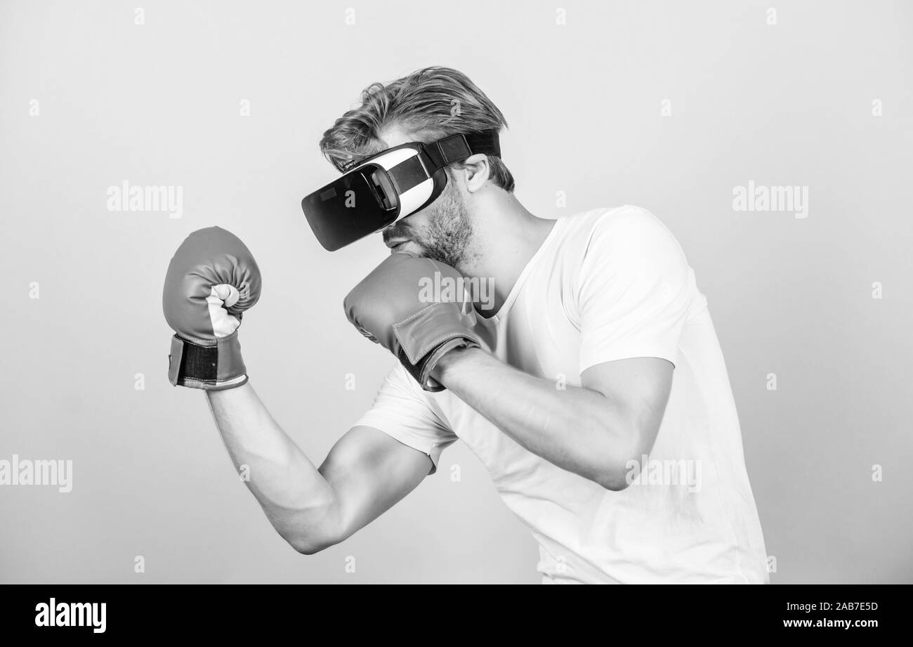 boxing in virtual reality. Digital sport success. man in VR glasses. Futuristic gaming. vr boxing. future innovation. man use new technology. modern gadget. Training boxing game. Great progress. Stock Photo