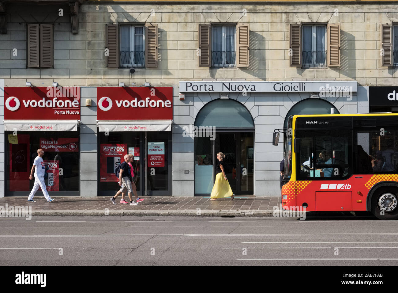 Italy, Bergamo, Lombardy: pedestrians, Vodafone shop and bus to the airport in the lower city Stock Photo