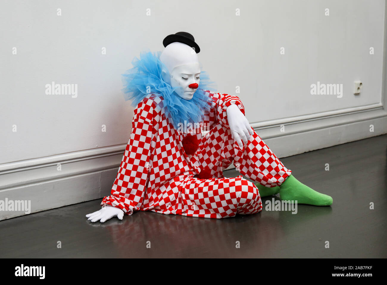 Hyper-realistic clown sculpture at 'everyone gets lighter' or 'vocabulary of solitude' by Ugo Rondinone in Helsingin Taidehalli, Helsinki, Finland Stock Photo