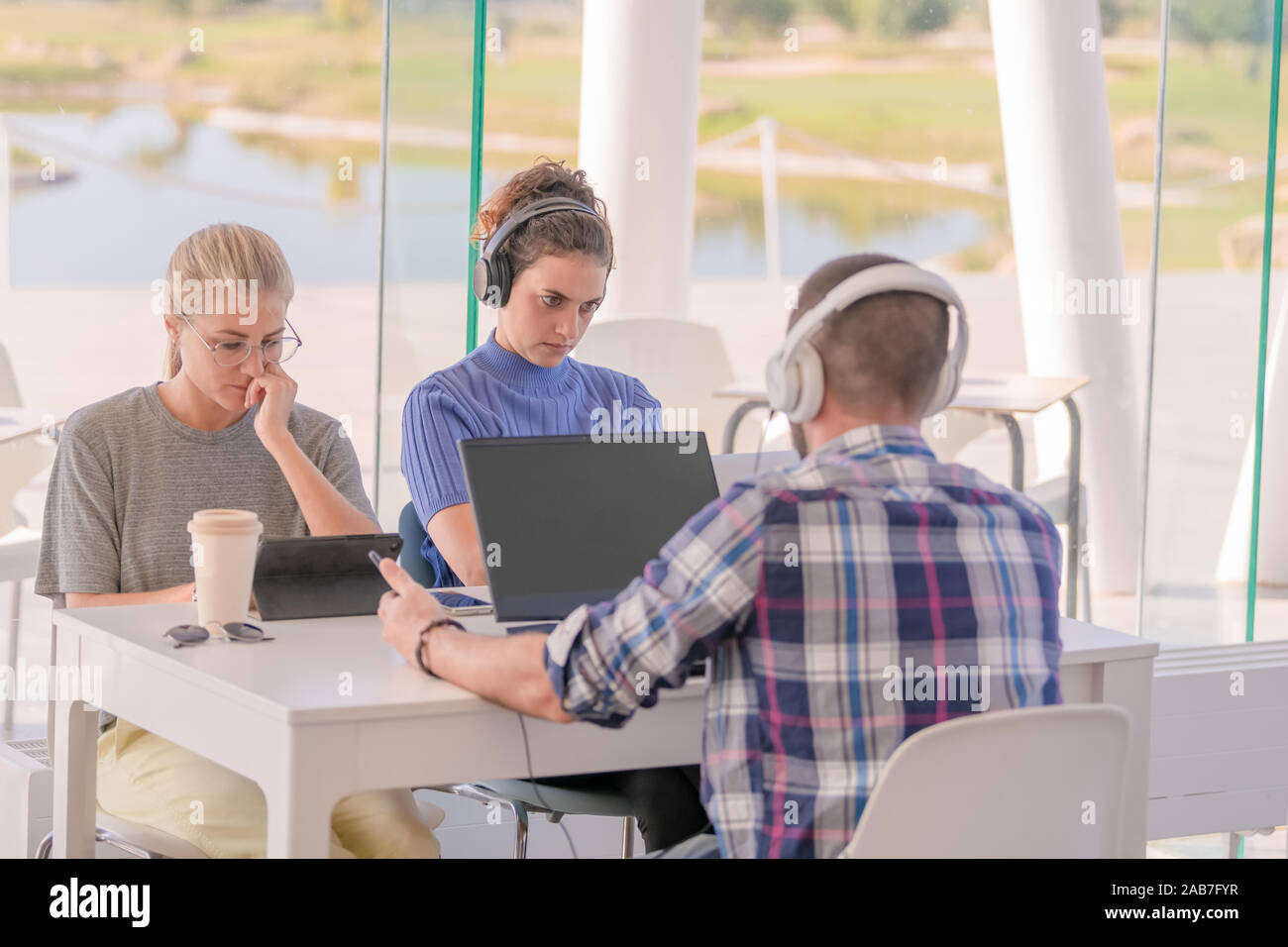 three university students in coffee shop Stock Photo Alamy