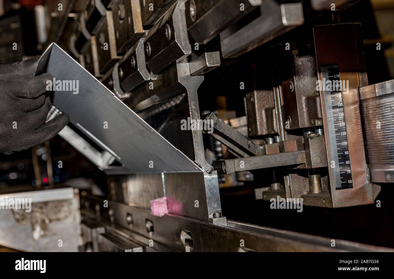 operator bending metal sheet by sheet bending machine bending of metal ...