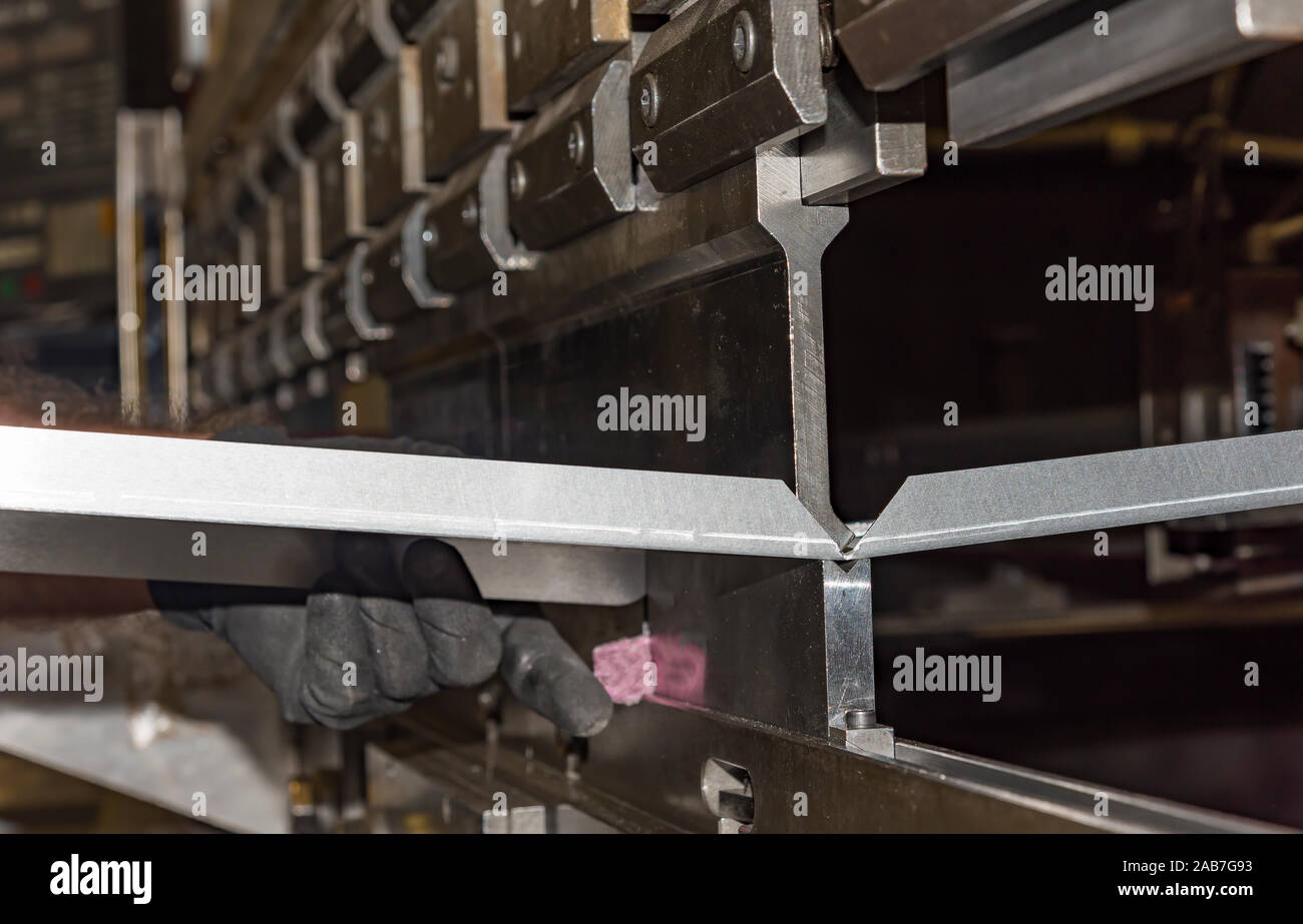 operator bending metal sheet by sheet bending machine bending of metal ...