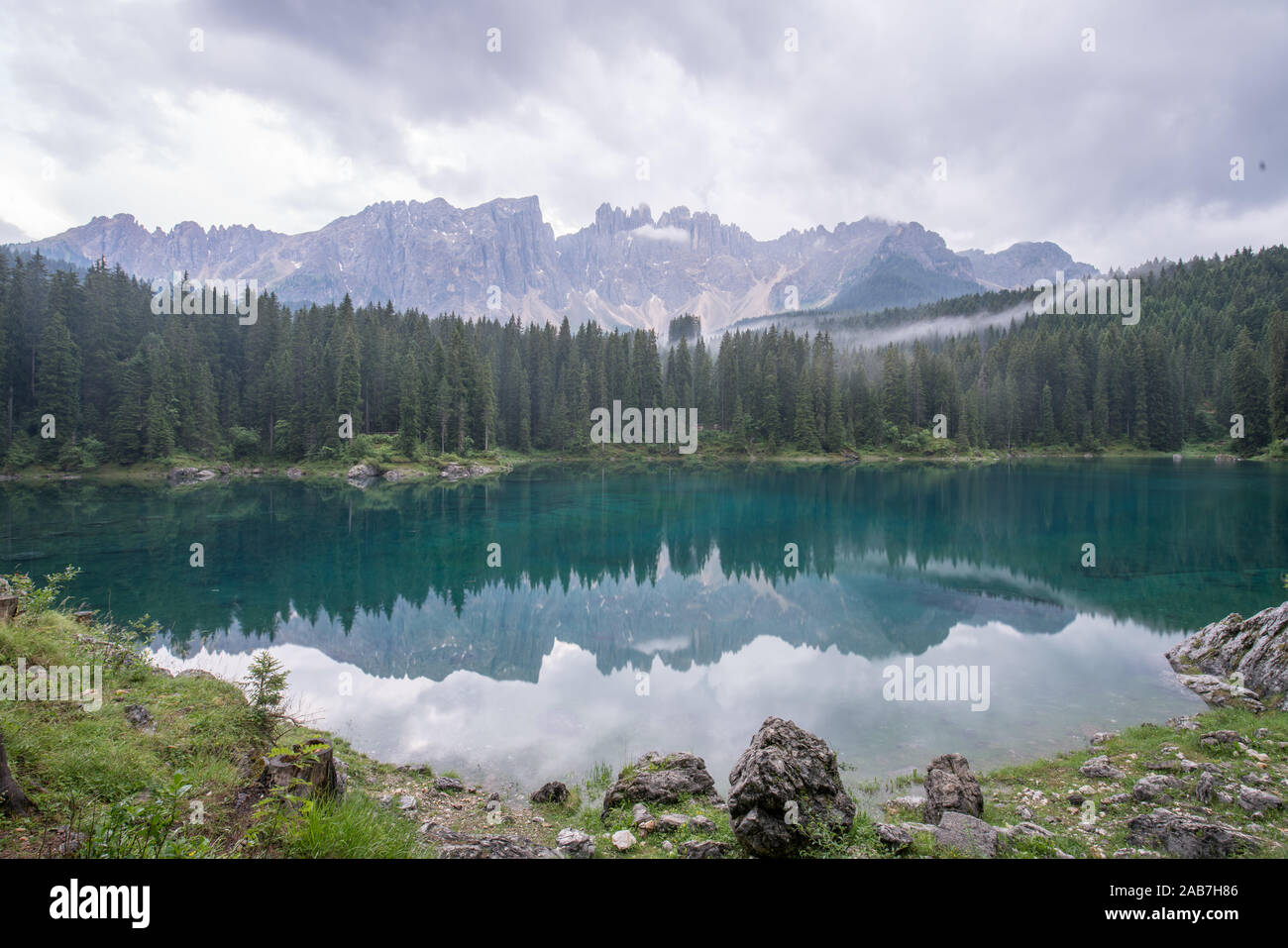 Cloudy day before raining in summer in Lago di Carezza and Latemar Mountain in the background in Welschnofen, South Tyrol, Italy Stock Photo